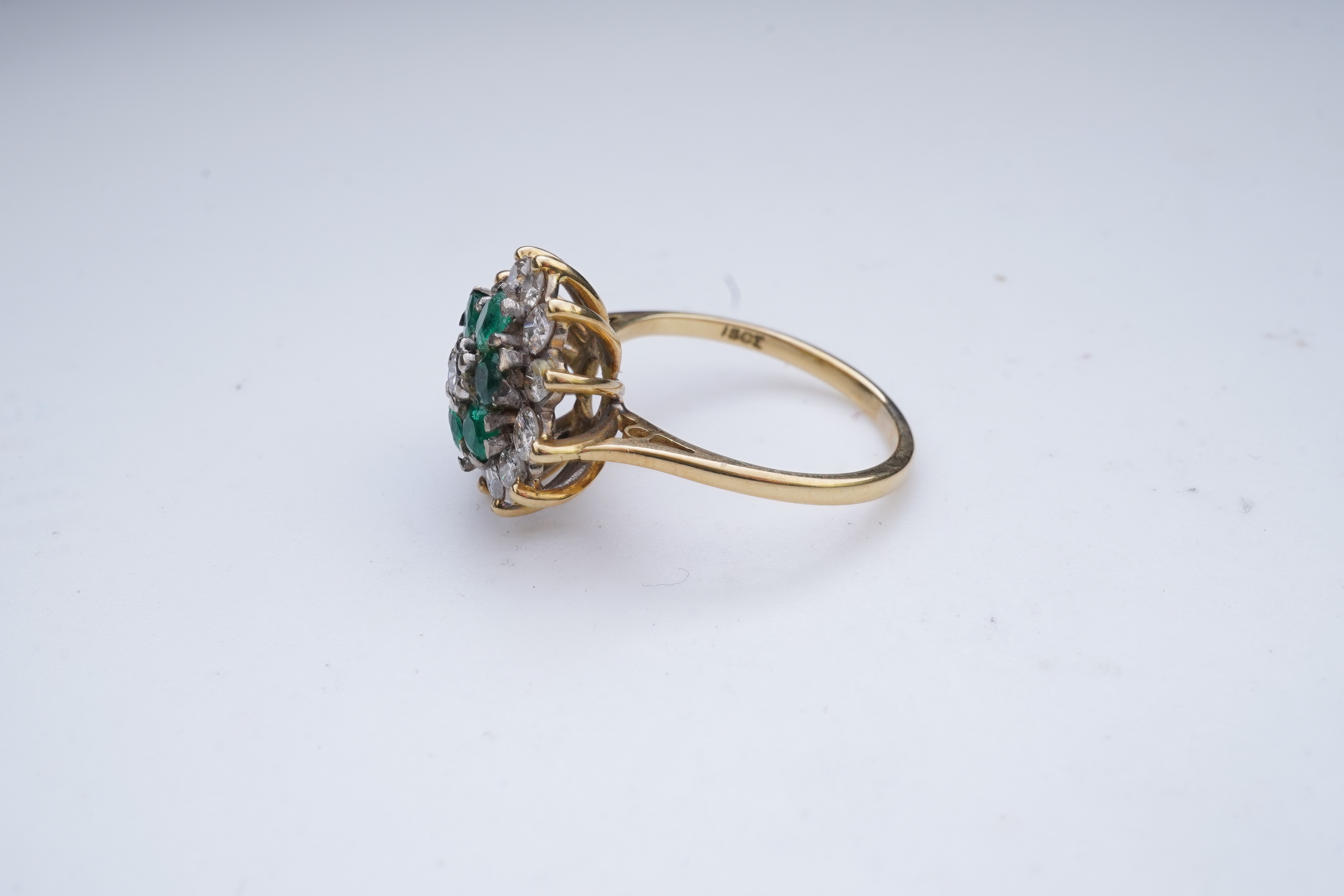 An emerald and diamond ring